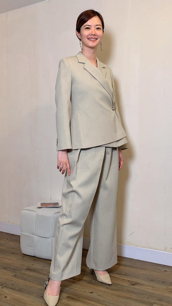 Greyish irregular cinched waist blazer and straight leg work pants