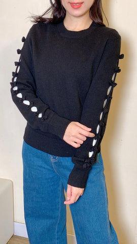 Black wool sweater with cut-out bow