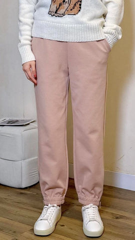 Pastel pink jogging pants with zipper bottom hem